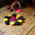 What are the most important benefits of playing the game of carrom through online systems?